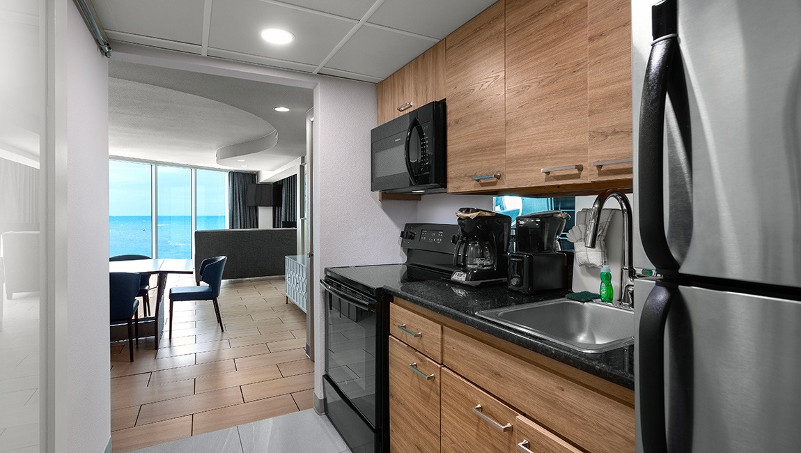 A kitchenette with a dining area and ocean view.