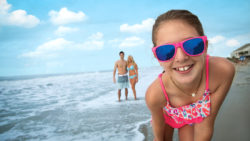 Girl wearing sunglasses on the beach