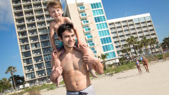 ather and son in front of the beachfront hotel