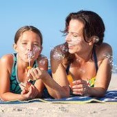 Mother and daughter blowing bubbles