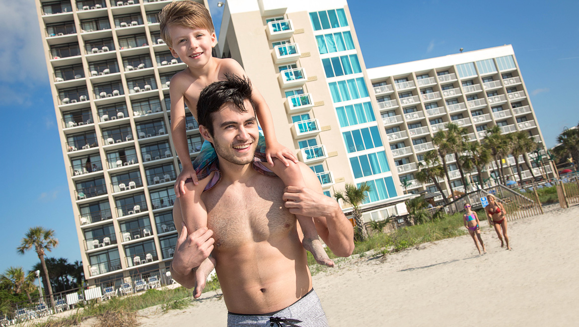Father and Son in front of oceanfront Captain's Quarters hotel