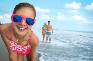 Girl wearing sunglasses on the beach