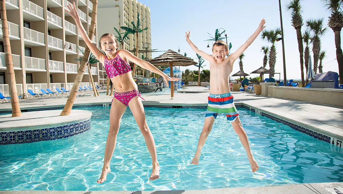 Kids Jumping At Outdoor Pool